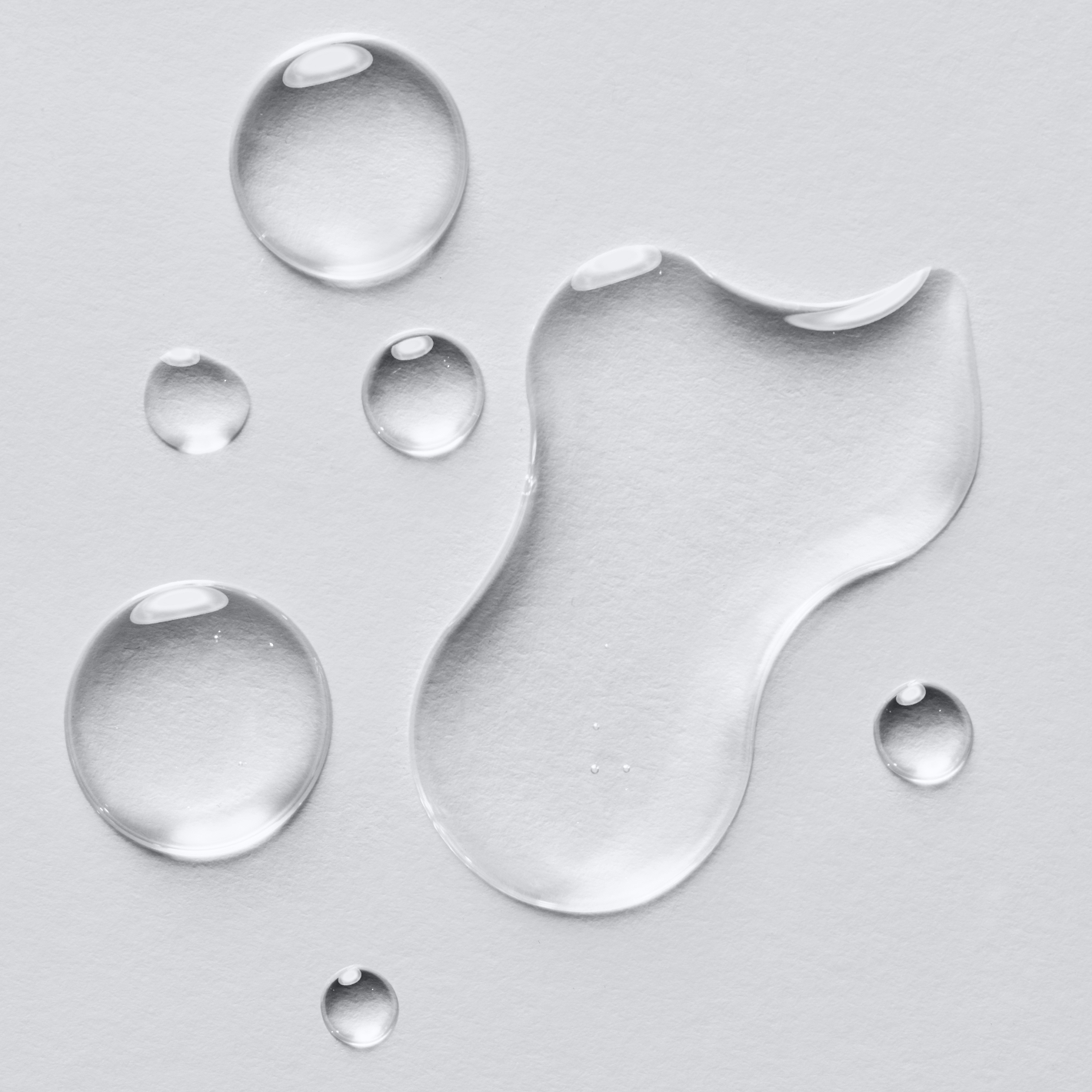 drops of water on a white surface.