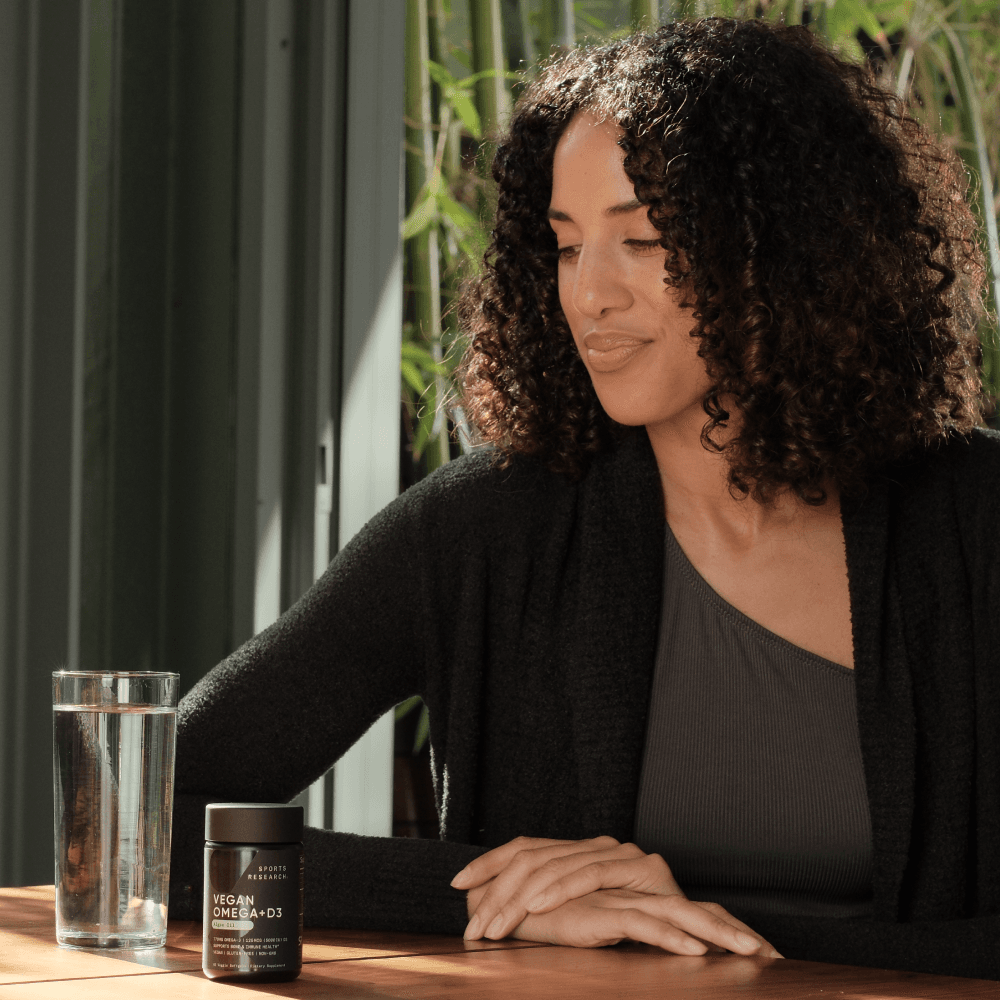 Lifestyle image of woman with vegan omega + D3