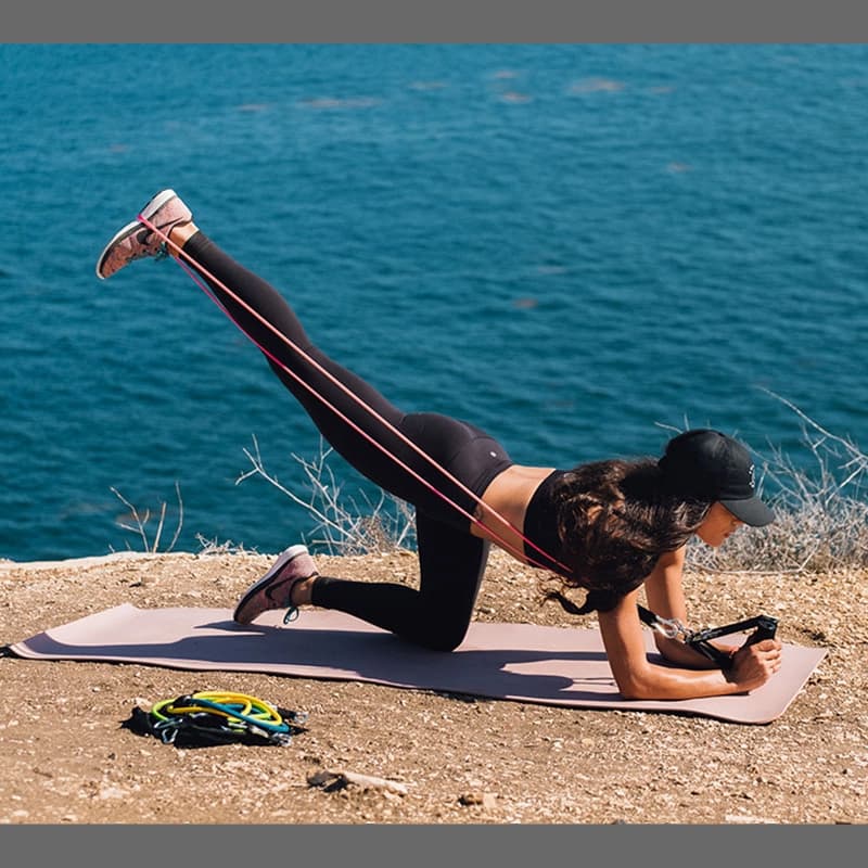 Woman using resistance bands.